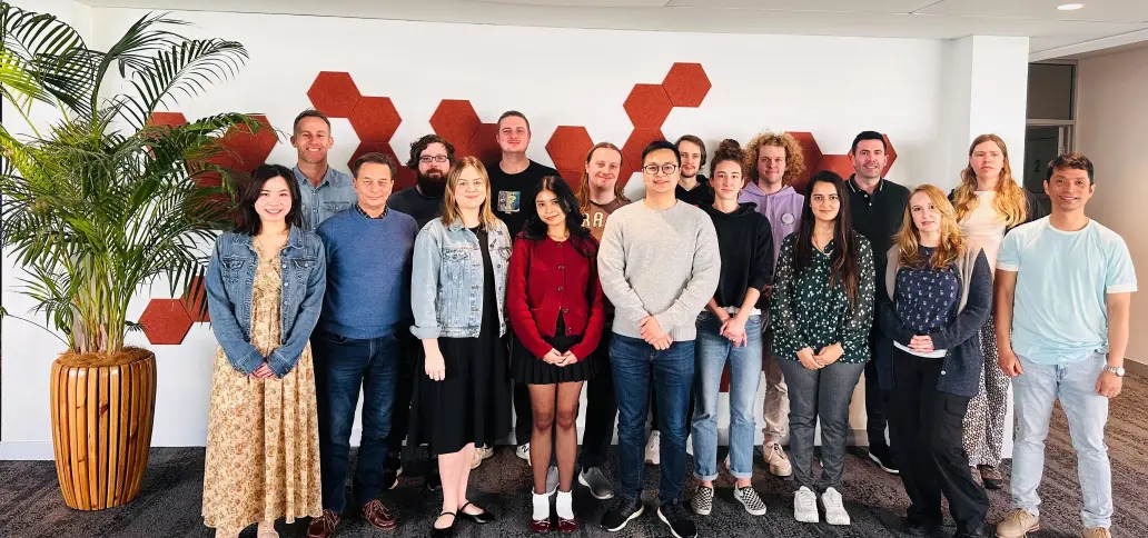 Group photo of the OneTouch Health Australia team standing together in an office